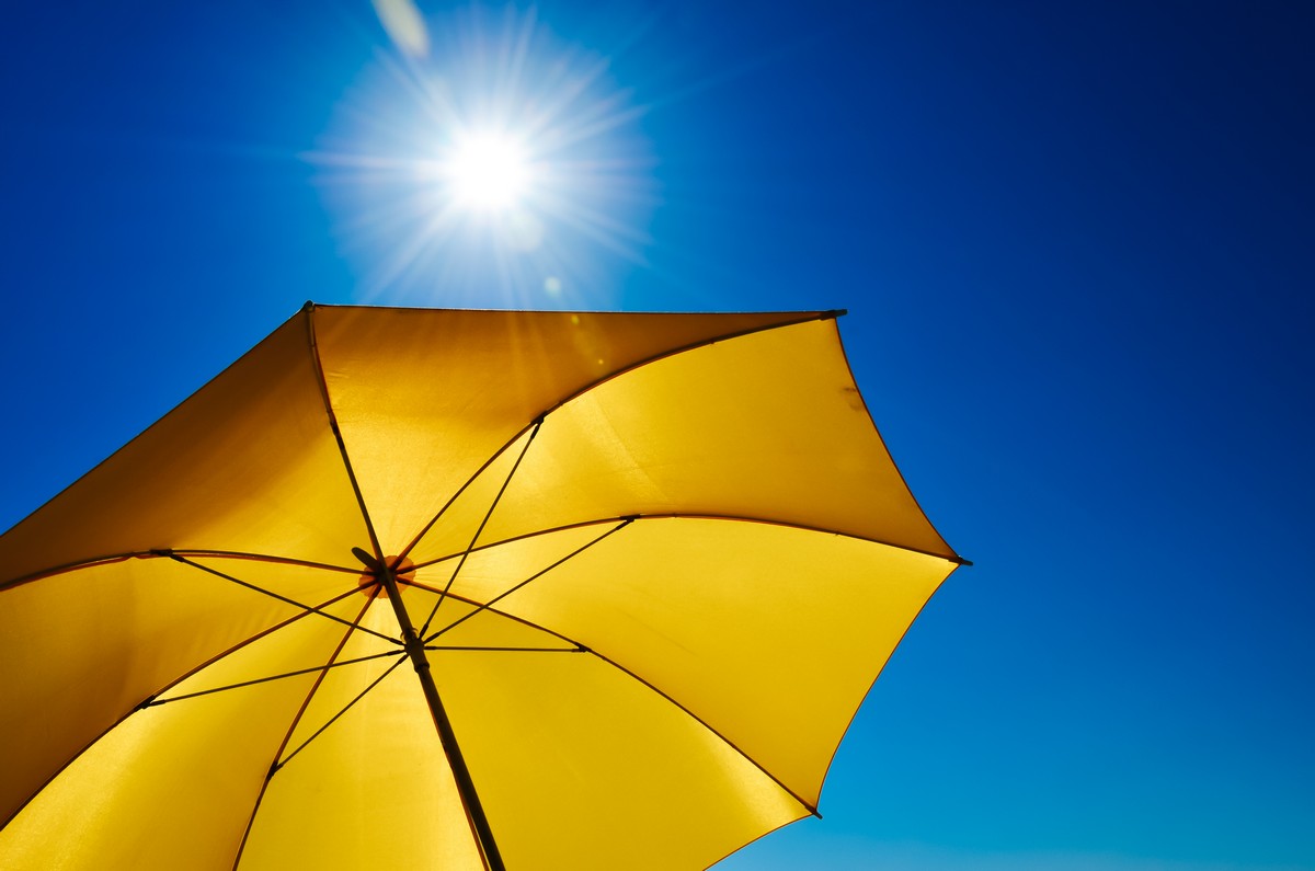 yellow umbrella blocking the sun’s rays