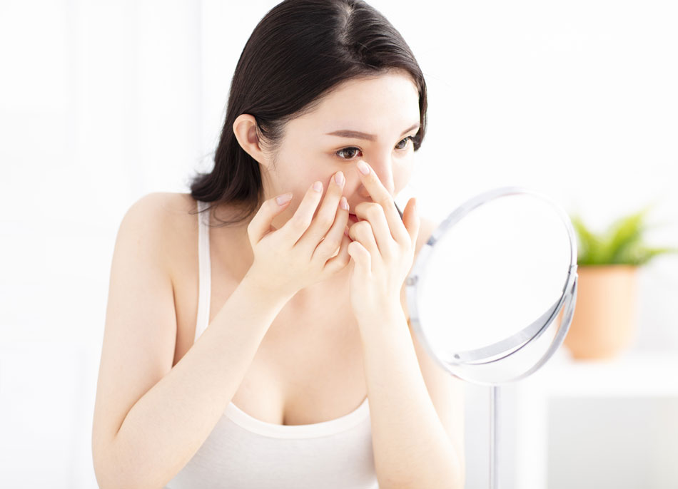 Young woman carefully inserting contacts