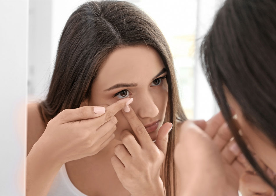 young woman inserting comfortable contacts
