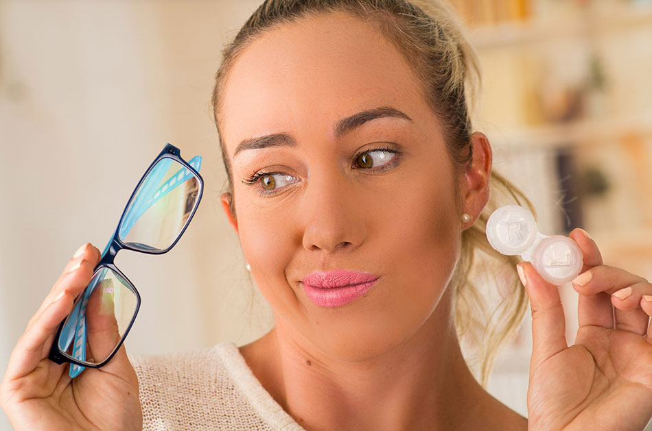 Young woman deciding between glasses and contacts with astigmatism